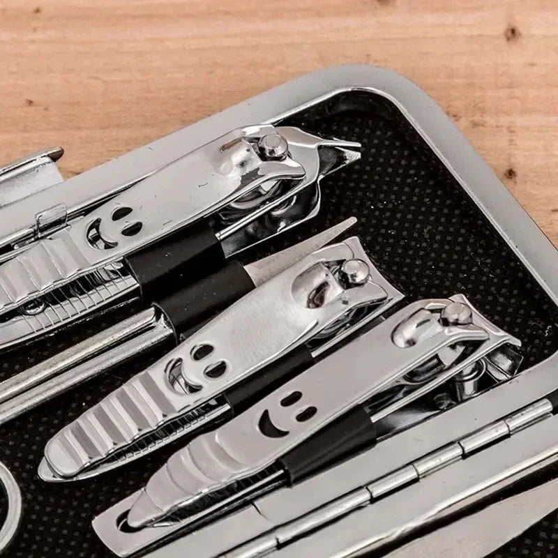 Set of nail clippers in a black case on a wooden surface