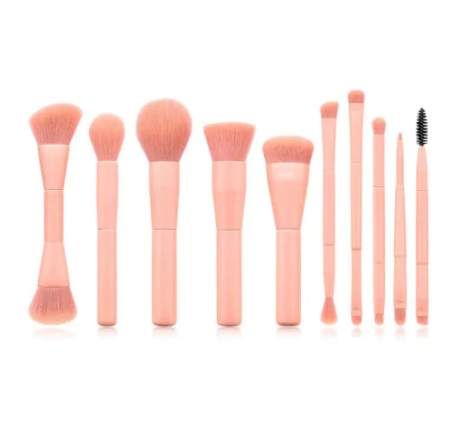Set of pink makeup brushes on a white background