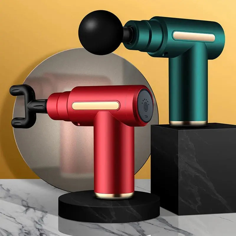 Red and green handheld massage devices on a marble surface with a yellow background