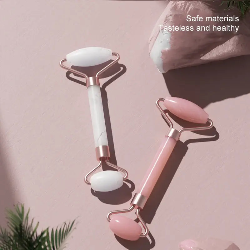 Two facial rollers on a pink background with text 'Safe materials Tasteless and healthy'.