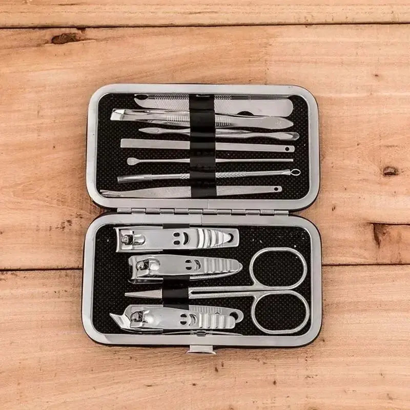 Manicure set with tools in an open case on a wooden surface