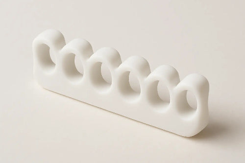 White ceramic utensil holder with wavy design on a light beige background