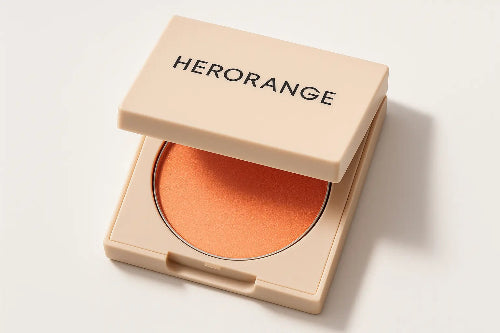 Open makeup compact with orange blush and 'HERORANGE' branding on a light background