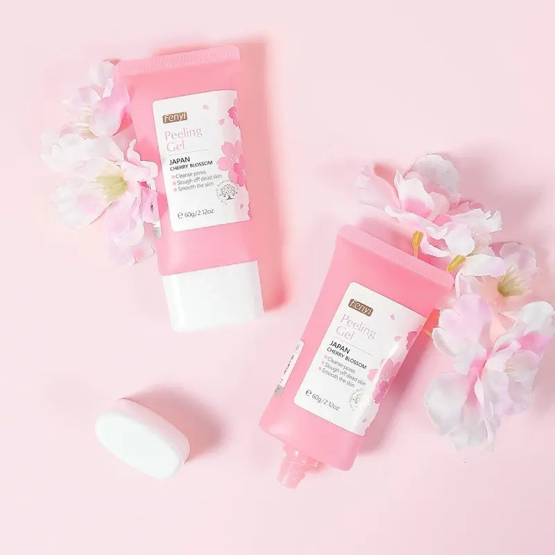 Two pink skincare products with floral elements on a pink background
